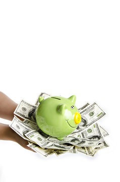 woman holding a lot of money and piggy bank