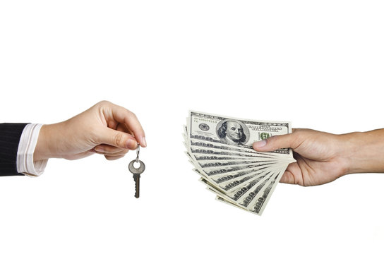 hand holding key and holding money for a deal of buying house