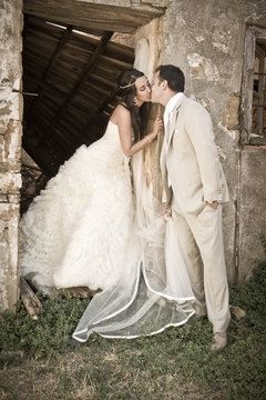 Attractive young bridal couple standing in doorway outdoors