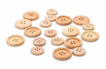 Obraz premium Wooden buttons on white surface