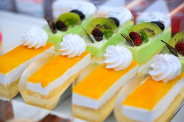 close-up sweet cake set on wooden table.