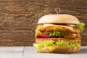 Chicken burger with cheese, lettuce, tomato and onion