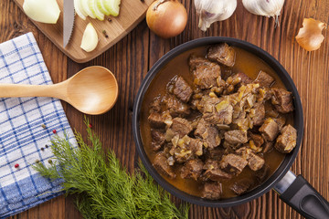 Beef stew - wooden background