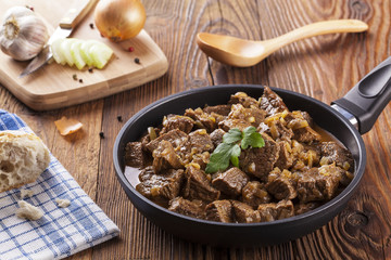 Beef stew - wooden background