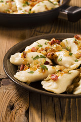 Delicious homemade dumplings with onion and bacon - obrazy, fototapety, plakaty