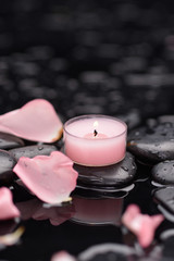 rose petals with candle and therapy stones