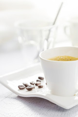 Cup of coffee on white wooden background