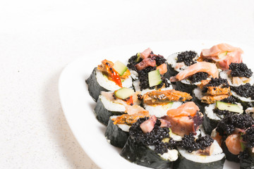 Homemade sushi in a white plate with wasabi and caviar