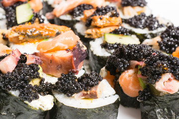 Homemade sushi in a white plate with wasabi and caviar