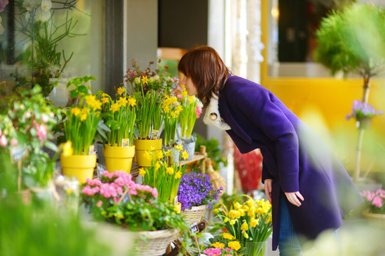 Beautiful Woman Selecting Flowers At Flower Market