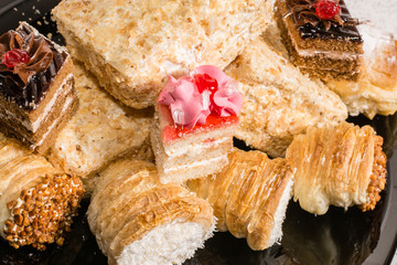 Various desserts with cream topping, coconut and powdered sugar