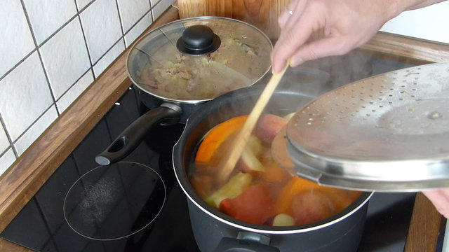 Stirring pumpkin and apple soup.