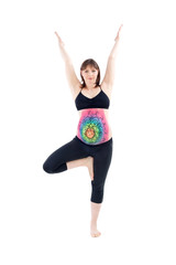 Woman with painted belly doing yoga exercises