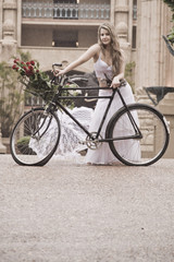 Fototapeta premium Young attractive woman outdoors with vintage bicycle