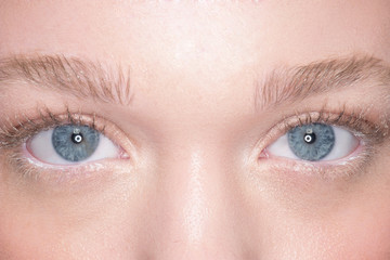 Fototapeta na wymiar Lovely blue eyes of a young woman