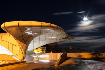 Full moon at the lift stop in Alpine mountains at night.