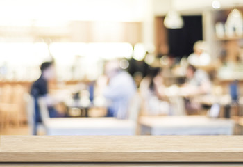 Empty wood table and blurred cafe with bokeh light background