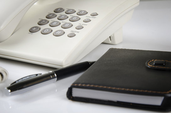 Office Telephone and black note book
