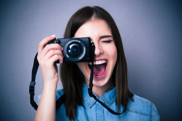 Cheerful young woman making photo on camera