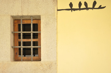 Wooden window in a yellow wall