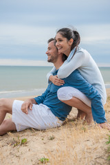 Naklejka na ściany i meble a beautiful couple is holding eachother at the beach