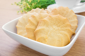 Butter cookies in bowl and coffee cup