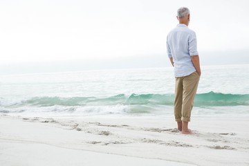 Thoughtful man standing by the sea