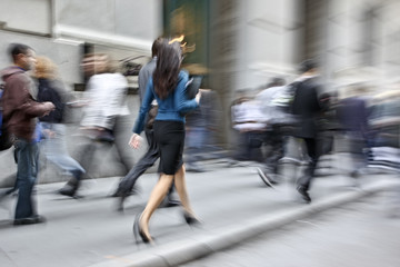 motion blurred business people walking on the street