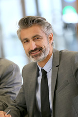 Portrait of mature businessman in a work meeting