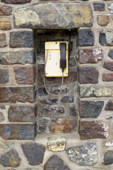 Yellow coastguard phone at Mullion, Cornwall, England