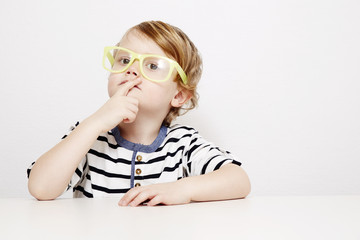 Young boy in yellow specs