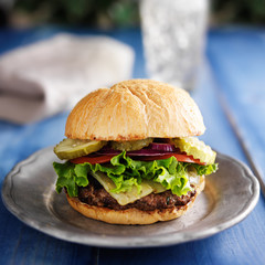 thick burger on rustic table top