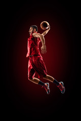 Fototapeta na wymiar Basketball player in action is flying high