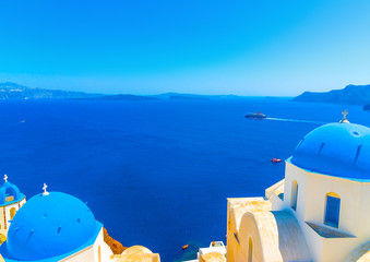 Fototapeta premium churches with blue domes in Oia at Santorini island in Greece