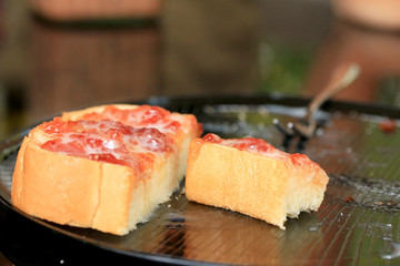 Toast with butter and sprinkling with sugar.