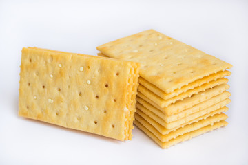 Stack of butter crackers on white background