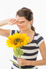 Playful woman with sunflower