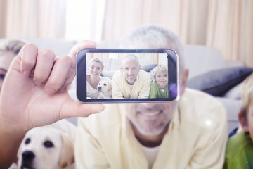 Composite image of hand holding smartphone showing