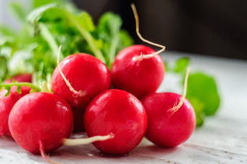 Bunch of fresh radishes on white board