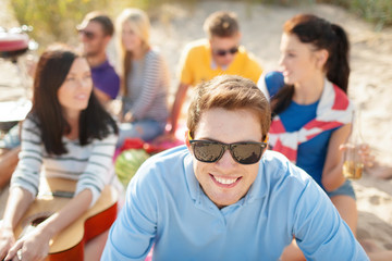 group of happy friends having fun on beach