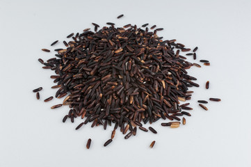 heap of black rice isolated on white