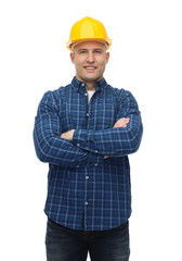 smiling male builder or manual worker in helmet