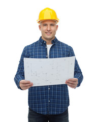 smiling male builder in helmet with blueprint