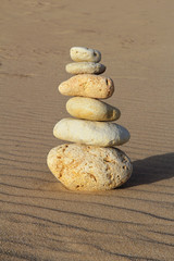 Fototapeta na wymiar stack of pebble on sandy beach