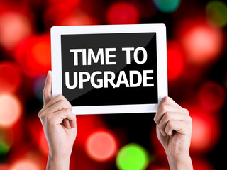 Tablet pc with text Time To Upgrade with bokeh background