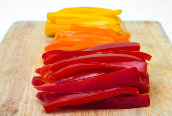 Red orange yellow peppers sliced