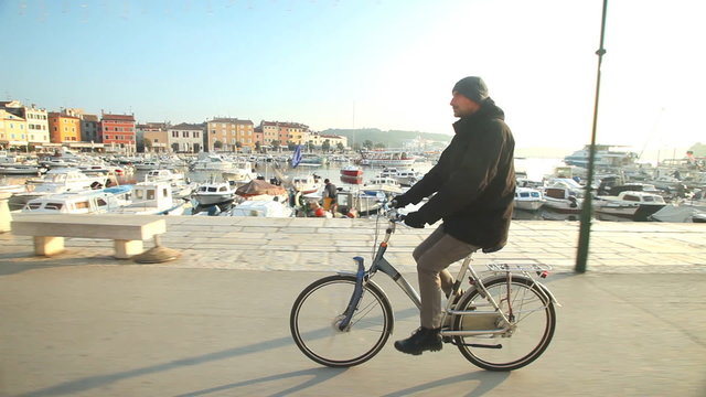 Man cycling on road in Rovinj, Croatia.