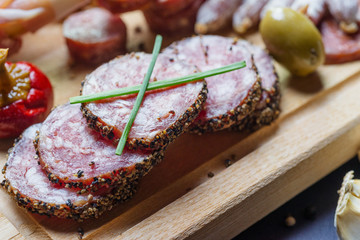 mix of spanish salami with vegetables and olives