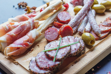 mix of spanish salami with vegetables and olives