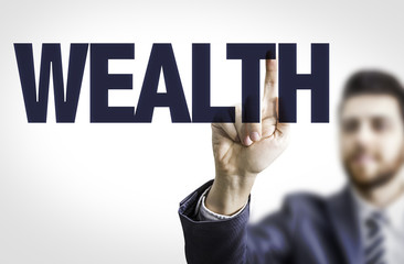 Business man pointing the text: Wealth